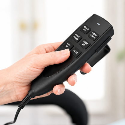 A hand holds a black remote with buttons—Head Up, Head Down, Foot Up, Foot Down, Lift Up, and Flat—used to adjust the EZLift Bed™ - Sleep To Stand Bed for greater independence and mobility.