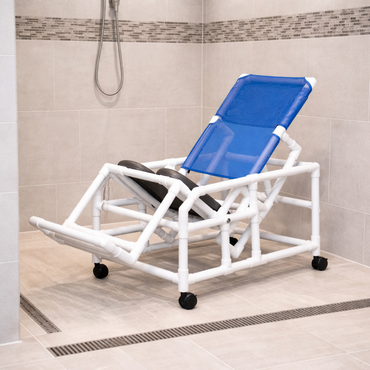 The IPU Easy-Tilt PVC Reclining Rolling Shower Chair features a blue mesh seat, sturdy white PVC frame, and smooth-rolling wheels, offering comfort and easy access in tiled shower rooms with handheld showerheads and floor drains.