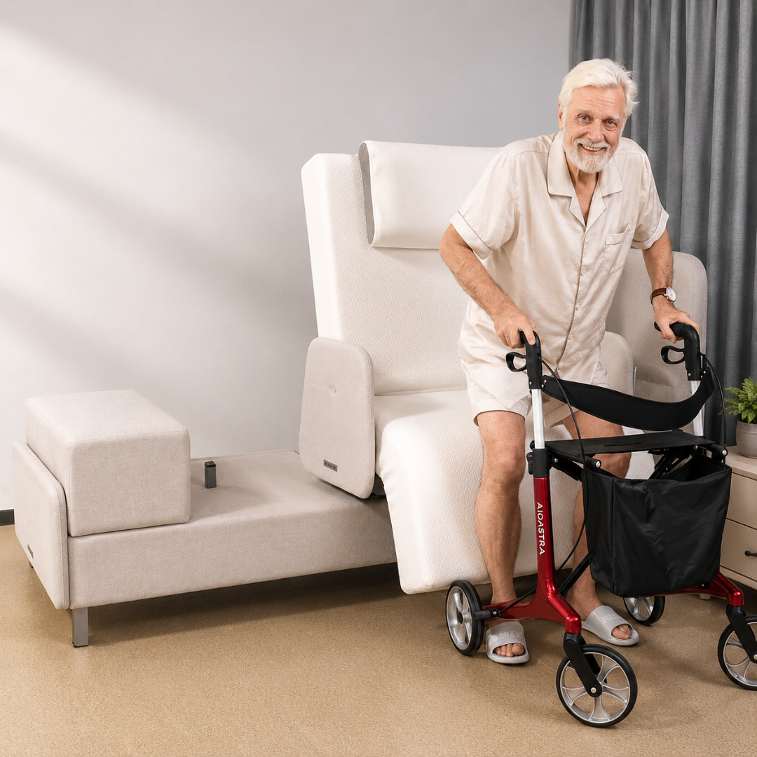 An elderly man with white hair and beard stands using a red walker beside an Elevra Deluxe Rotating Lift Assist Bed - Dual King, a modern light-colored bed with an adjustable, cushioned backrest for advanced homecare.