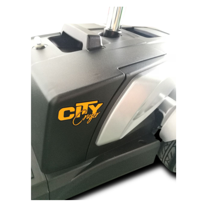 Close-up of a black and gray EV Rider CityCruzer Portable Scooter showing part of the base and wheels, with "CITY" in bold yellow letters and "Cruzer" in cursive on the side.
