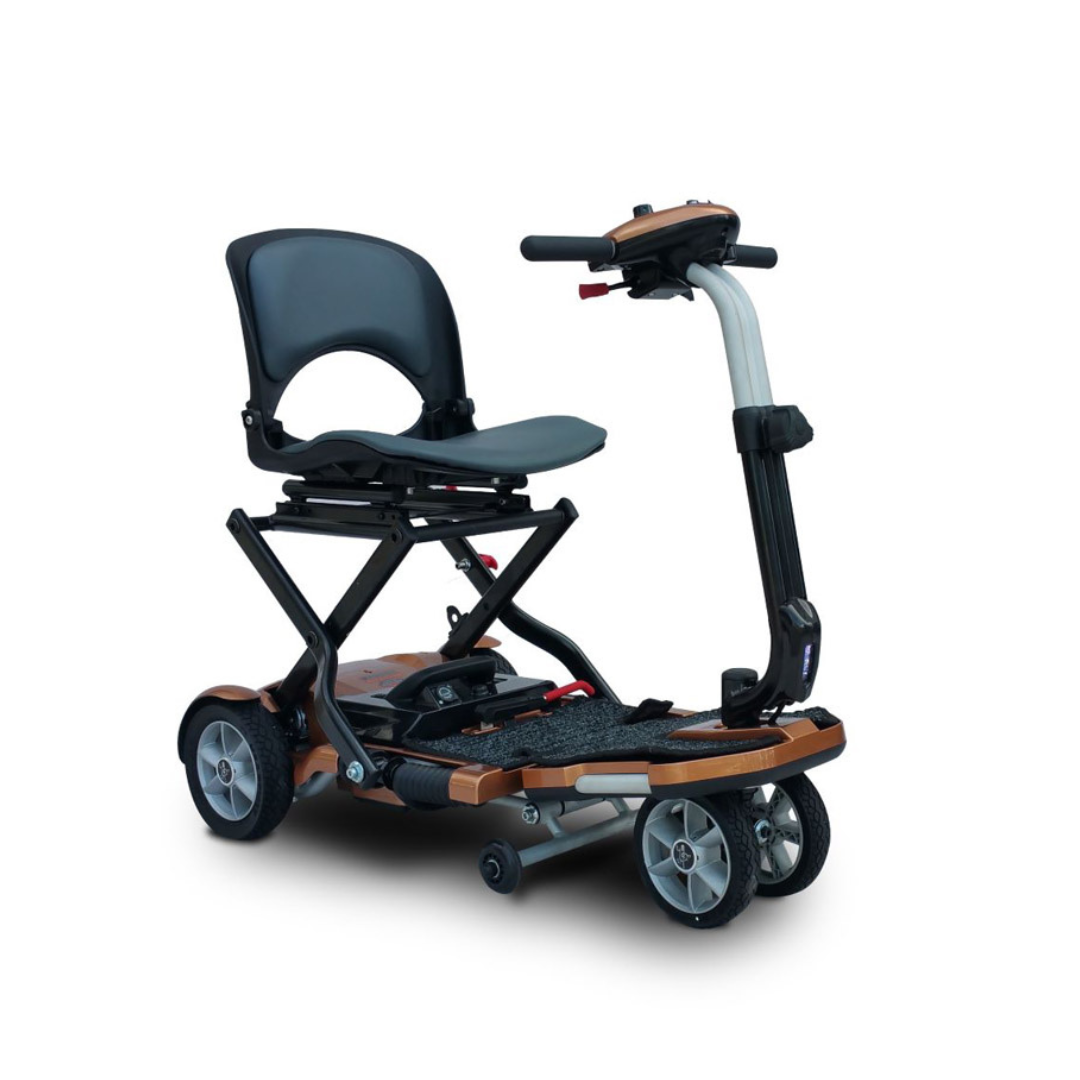 The EV Rider Transport Plus Portable Mobility Scooter features a compact, foldable design with a black cushioned seat, four wheels, handlebars, and a sturdy frame for easy transport and dependable mobility assistance.