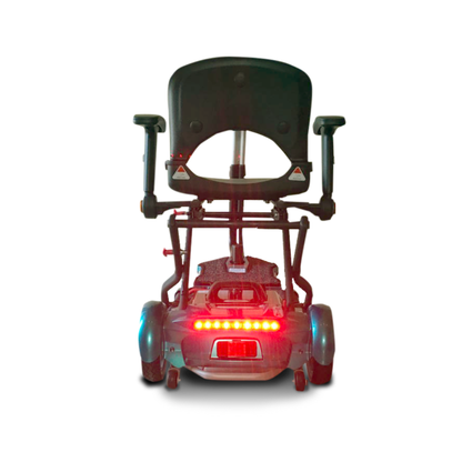 Rear view of the EV Rider Transport Plus Portable Mobility Scooter with armrests, black seat, and red rear lights on a white background—perfect for travel thanks to its foldable, portable design.