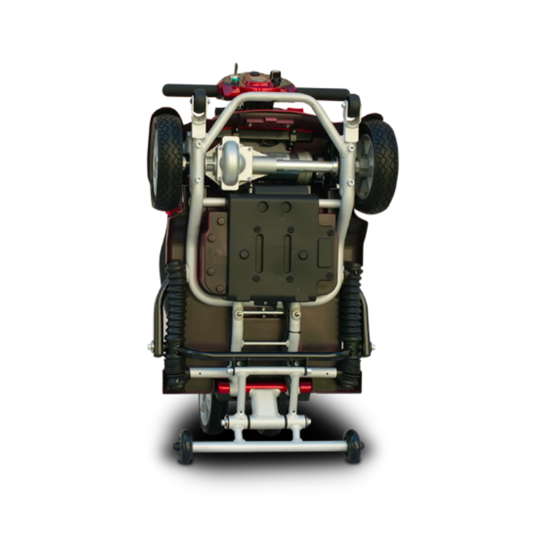 Bottom view of the EV Rider Transport Plus Portable Mobility Scooter, displaying its wheels, metal frame, battery, and mechanical parts—an airline-safe foldable scooter shown on a plain white background.