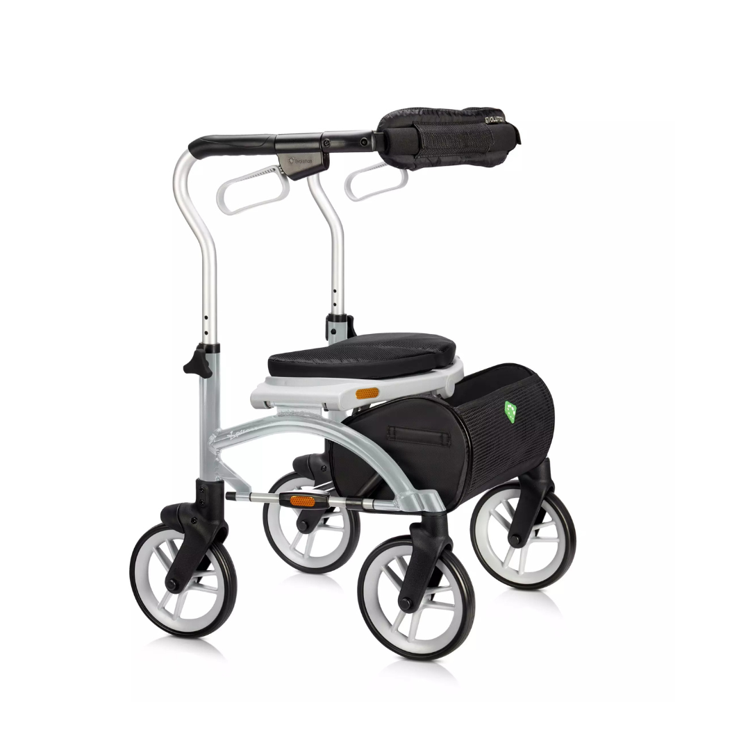 The Evolution Xpresso Lite Carbon Fiber Rollator is an ultra-lightweight, modern walker with four wheels, a padded seat, ergonomic handles, a detachable under-seat storage bag, and a zippered pouch on the handlebar—ideal for daily mobility.