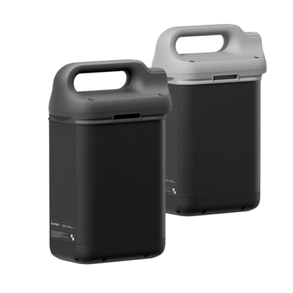 Two rectangular, black Extra Batteries designed for Strutt ev1 compatibility are shown upright. Each features a large top handle and a modern, minimal design—one with a dark gray lid and the other with a light gray lid. Available in both Long-Range and Flight-Safe Battery configurations.