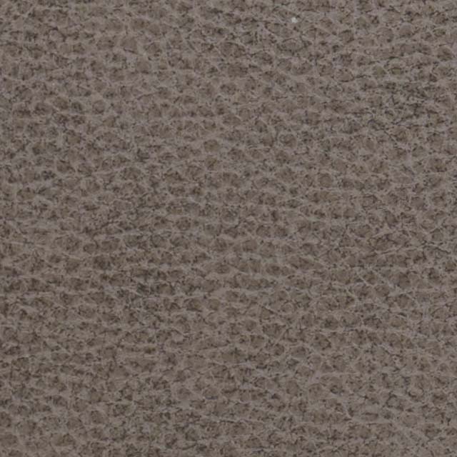 Close-up of a textured gray-brown surface, akin to the luxurious finish of a Golden Tech Rhea PR442 MaxiComfort Recliner with Lift Assist & HeatWave, showcasing a pebbled pattern and irregular shapes.