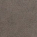 Close-up of a textured gray-brown surface, akin to the luxurious finish of a Golden Tech Rhea PR442 MaxiComfort Recliner with Lift Assist & HeatWave, showcasing a pebbled pattern and irregular shapes.