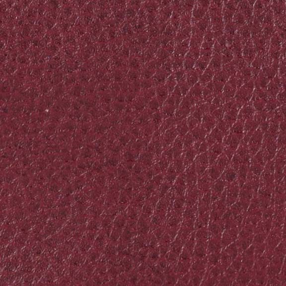 Close-up of maroon leather with fine wrinkles and pores, creating a grainy texture like the luxurious Golden Tech PR510 MaxiComfort Cloud Recliner With Lift Assist - Extra Wide. The rich color resembles the inviting warmth of Full Body Heat Wave Technology.