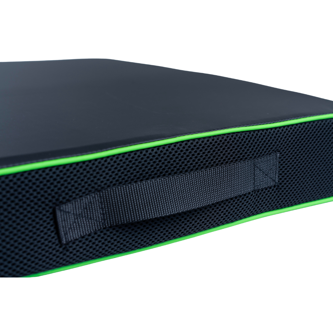 Close-up of the Feather Portable Cushions – All Purpose Cushion in black, with a textured side, sewn-in handle, and bright green piping for easy transport.