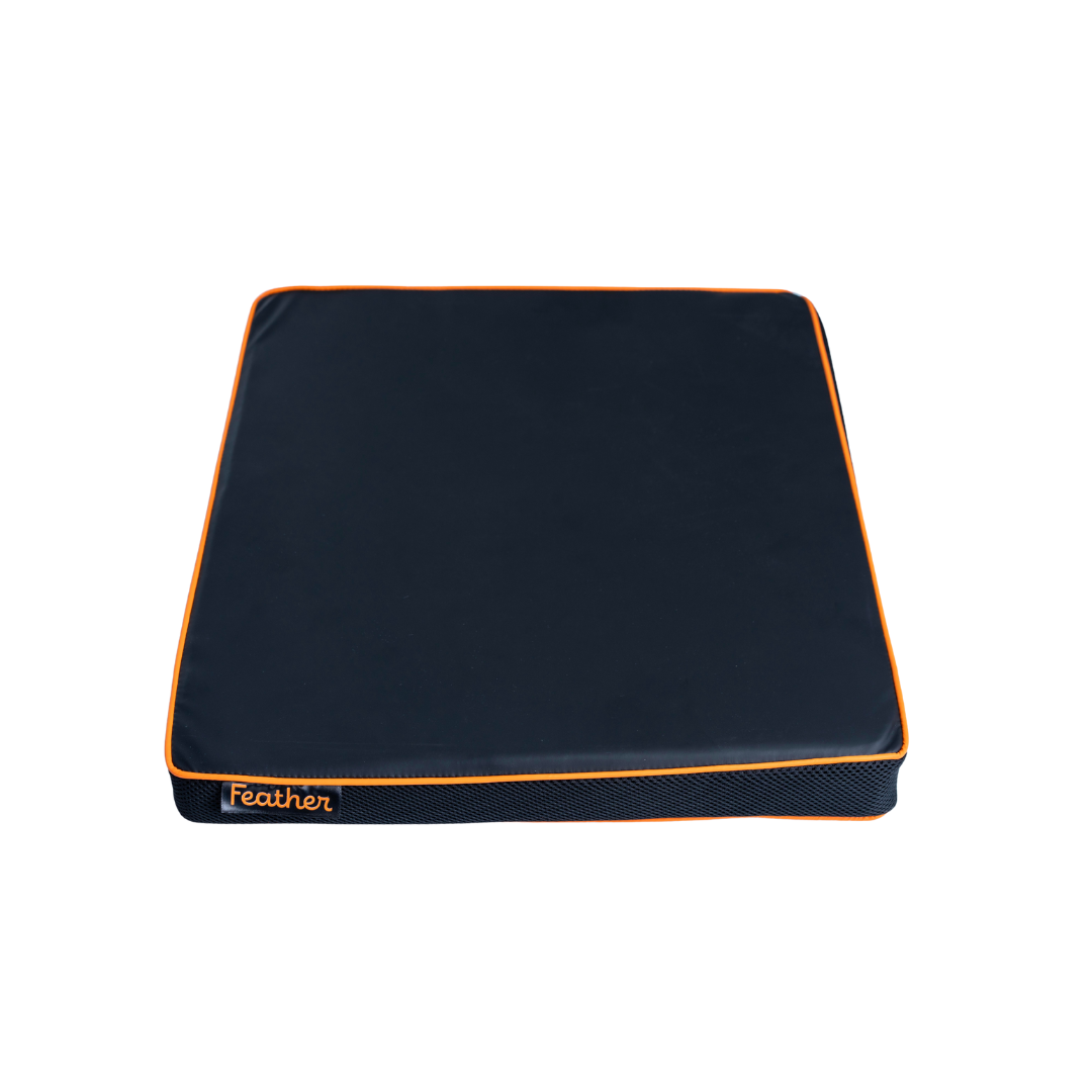 The Feather Portable Cushion is a square, dark blue memory foam cushion with orange piping and the word "Feather" stitched in orange, featuring a water-resistant cover and handle, shown against a white background.