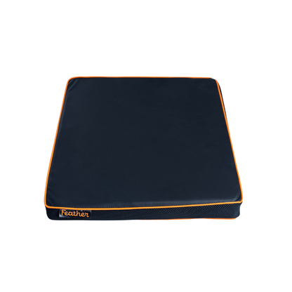 The Feather Portable Cushion is a square, dark blue memory foam cushion with orange piping and the word "Feather" stitched in orange, featuring a water-resistant cover and handle, shown against a white background.