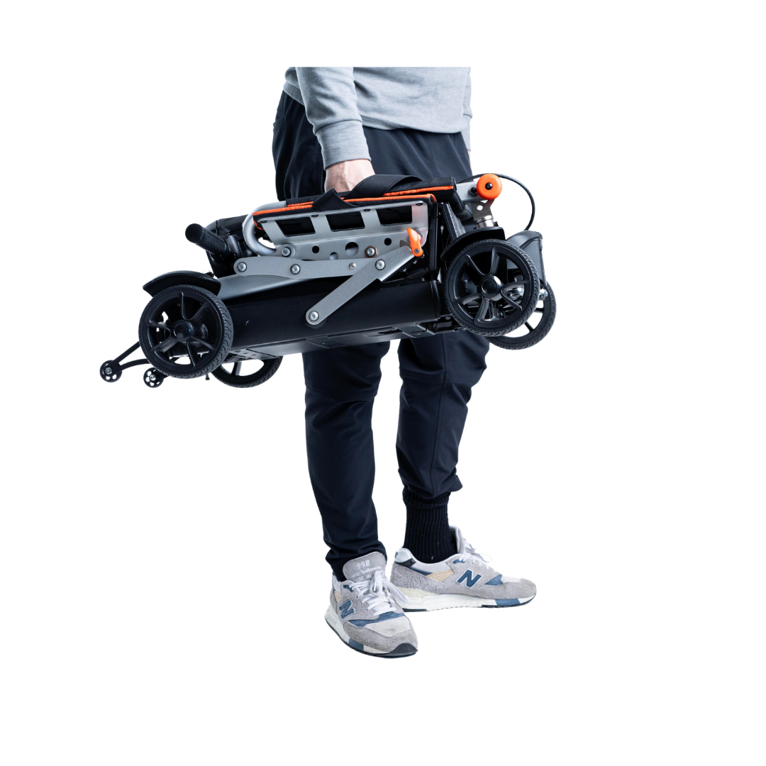 A person in sneakers and dark pants holds the Feather 27X Folding Portable Mobility Scooter—only 27 lbs—by its handle, highlighting its compact and sleek design against a white background.