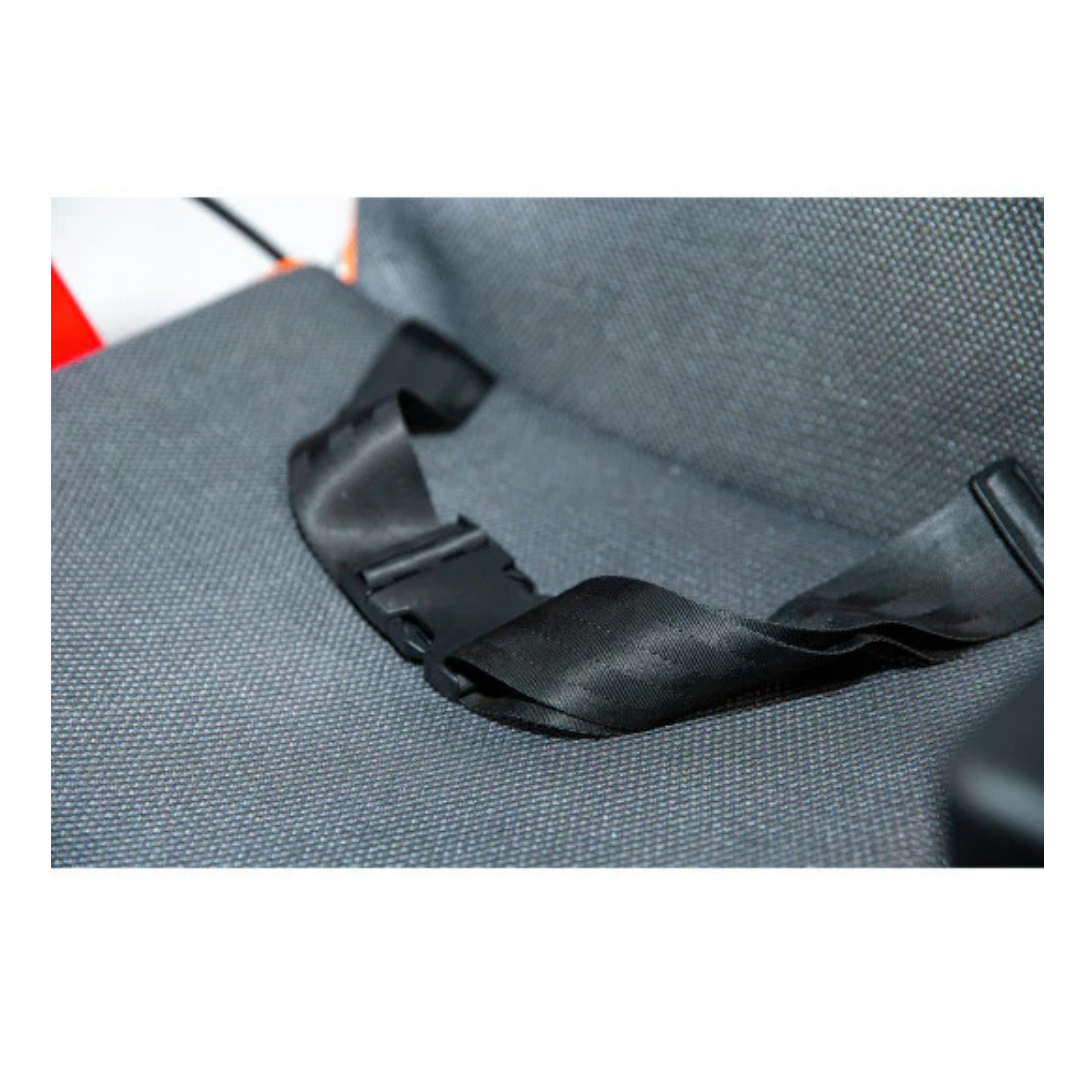 A close-up of a black seat belt buckle and strap on a textured gray car seat, a safety feature of the Feather Powerchair—Ultralight Travel Approved Electric Wheelchair weighing only 33 lbs.