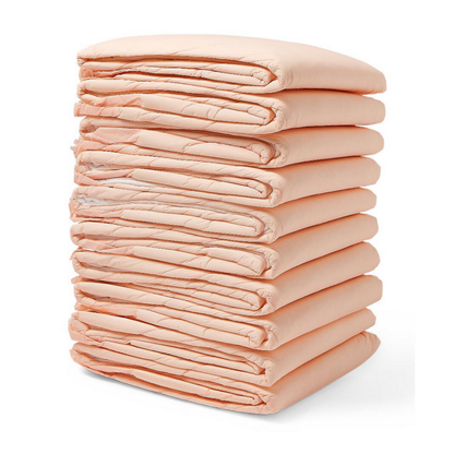 A neatly stacked pile of ten folded, peach Medline FitRight Underpads highlights incontinence products crafted for dependable absorbency and odor control on a crisp white background.