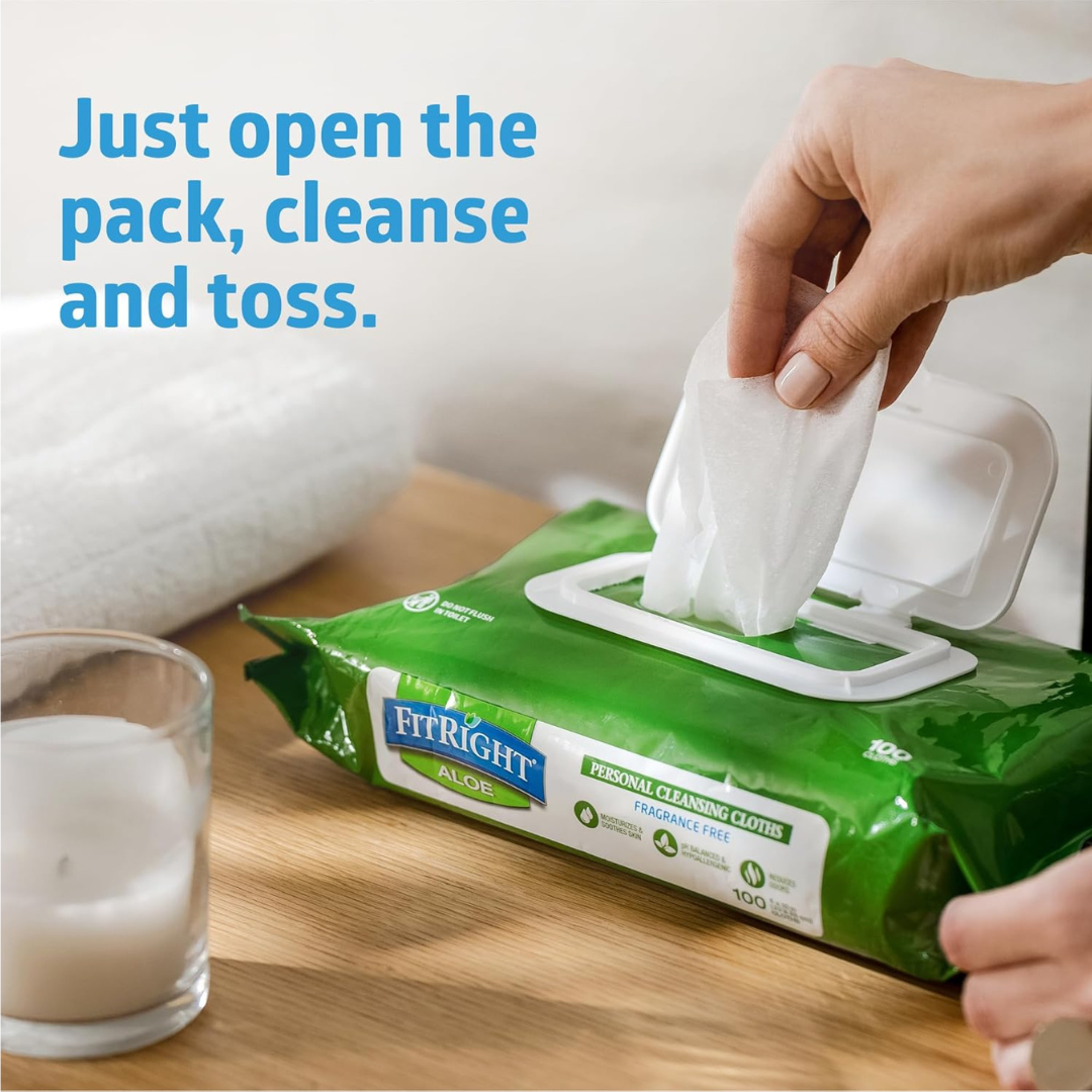 A hand pulls a FitRight Aloe Quilted XL Personal Cleansing Wipe from a green pack on a wooden surface, beside a lit candle and white towel. Blue text reads: Just open, cleanse, and toss—ideal for sensitive skin wipes users.