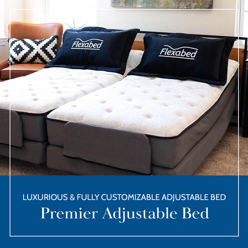 The luxurious Flexabed Premier Adjustable Full Electric Bed with Massage offers two separate reclining mattresses for targeted support. It features plush white bedding, dark pillows labeled Flexabed, and a striped cushion, enhancing both comfort and elegance.