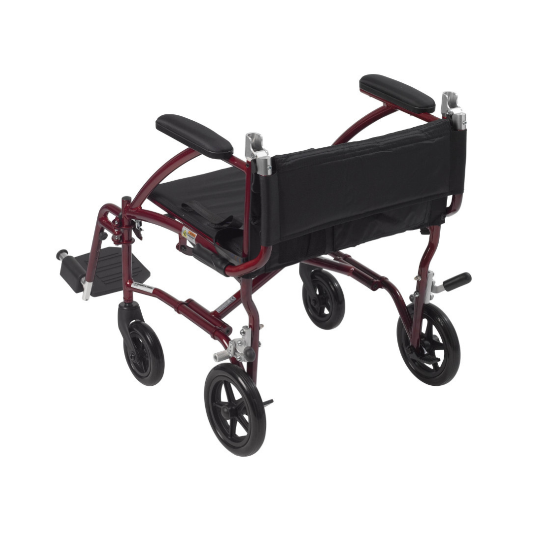 The Drive Fly-Lite Aluminum Transport Chair features a maroon metal frame, black seat and backrest, armrests, footrests, and four small black wheels, shown from a rear side angle.