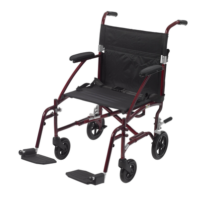 The Drive Fly-Lite Aluminum Transport Chair is foldable and lightweight, featuring a maroon frame, black seat and backrest, armrests, footrests, and four small wheels for easy portability.