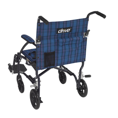 The Drive Fly-Lite Aluminum Transport Chair is shown from the back, featuring blue plaid fabric, black handles and footrests, and four small wheels. The brand name "drive" is printed on this ultra-lightweight folding wheelchair.