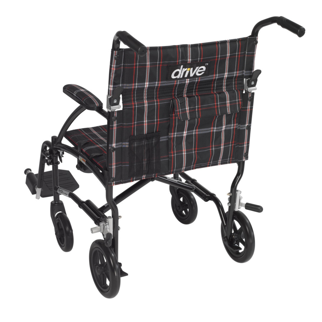 The Drive Fly-Lite Aluminum Transport Chair is a portable wheelchair with a black frame, plaid fabric seat and backrest, armrests, footrests, push handles, and "ultra-lightweight transport chair by drive" printed on the backrest.