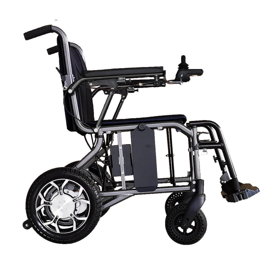 A side view of the Foldawheel ECO Lightweight Folding Powerchair shows large rear wheels, small front wheels, a footrest, and a right-arm joystick. Its metallic frame has a cushioned seat and backrest for comfort.