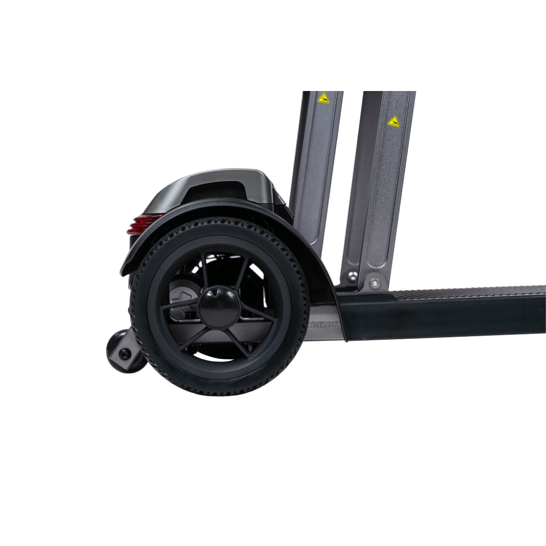 Close-up side view of the rear wheel and fender on the Forcemech PathMate Portable Mobility Scooter, featuring a solid black tire, sturdy frame, and small stabilizing wheel for easy mobility against a white backdrop.