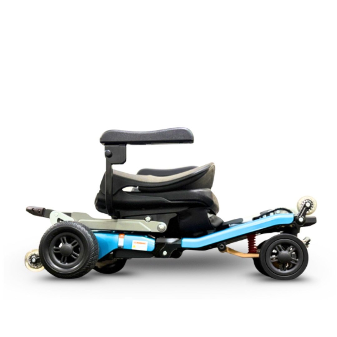 A side view of the FreeRider Luggie Super Plus 4 Travel Scooter, a compact mobility scooter with a low black cushioned seat and light blue frame, designed for personal transportation and everyday independence.