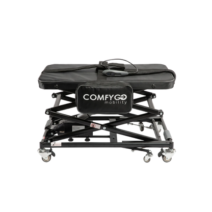 The ComfyGo GO-Lift Portable Lift for Electric Wheelchairs and Scooters is a black, adjustable mobility platform with wheels, featuring a cushioned top and a remote control attached by a coiled cord. Designed for easy patient transfer or lifting electric wheelchairs and scooters, this lightweight lift offers enhanced portability, support, and convenience.