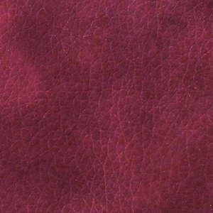 A close-up of textured dark red leather showcases natural patterns and a sophisticated shine, echoing the elegance of the Golden Tech PR449 Titan Recliner With Lift Assist, featuring ZG+ and Twilight technology for ultimate relaxation.