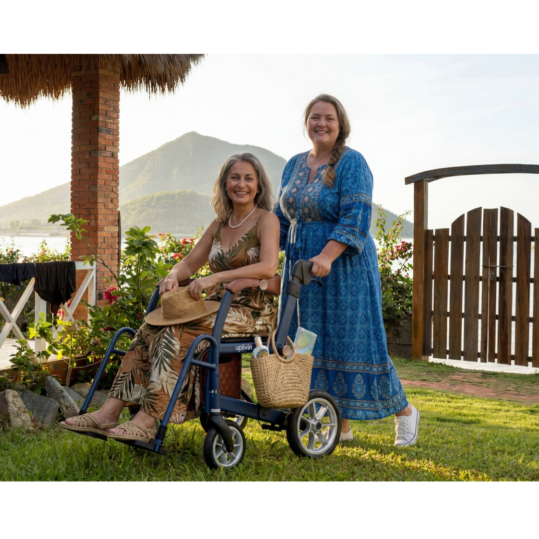 A smiling woman sits in a navy blue uplivin Gavo 2-in-1 Hybrid Rollator & Wheelchair, while another woman stands behind her outdoors.