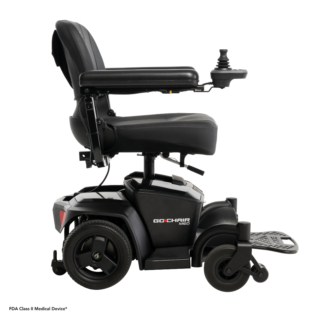 Side view of the Pride Mobility Go Chair® MED Portable Powerchair, featuring a padded seat, armrests, footrest, right-arm joystick controller, and four wheels—lightweight and portable, ideal for travel. Branding visible on the side.