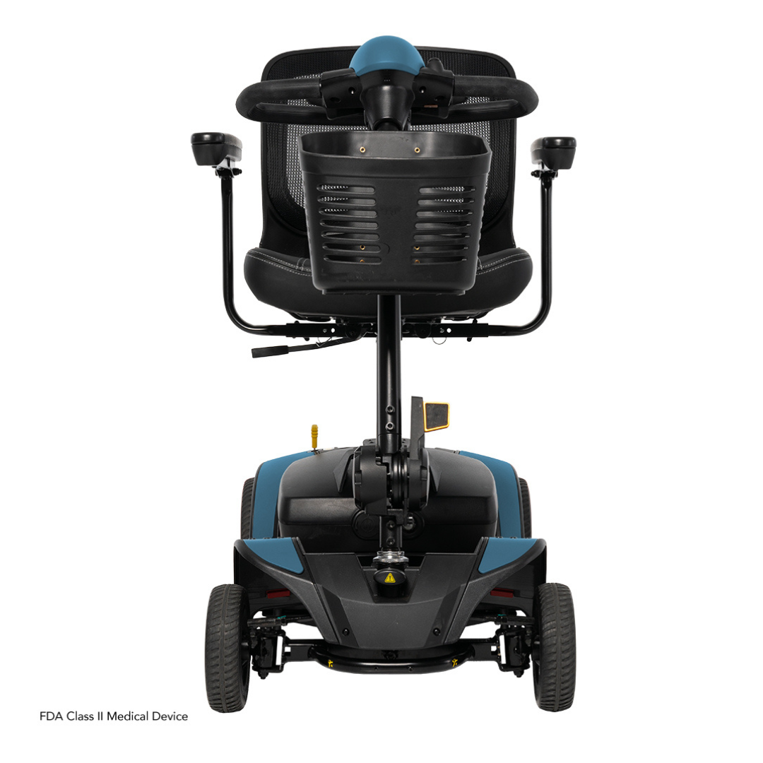 Rear view of a blue and black Pride Mobility Go Go Elite Traveller® 2 Platinum Scooter with padded seat, armrests, four wheels, EZ Turn technology; labeled as an FDA Class II Medical Device.
