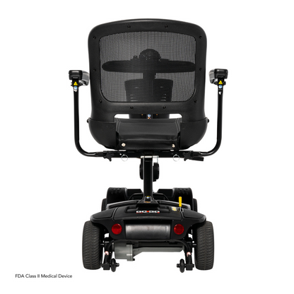 Rear view of a black Pride Mobility Go Go Elite Traveller® 2 Platinum Scooter with mesh backrest, armrests, and four wheels on a white background. Features EZ Turn technology, rear lights, and an FDA Class II Medical Device label.