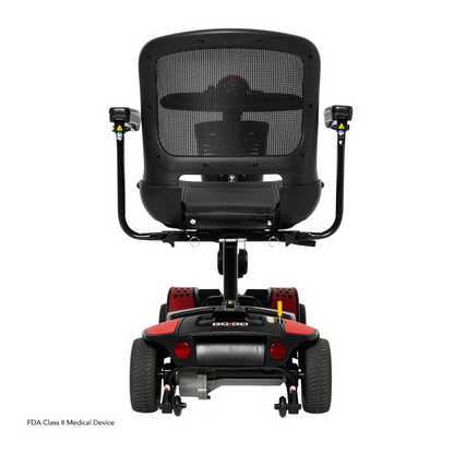 Rear view of a Pride Mobility Go Go Elite Traveller® 2 Platinum Scooter with a mesh backrest, two armrests, and four wheels on a white background. "FDA Class II Medical Device" text appears in the lower left corner.