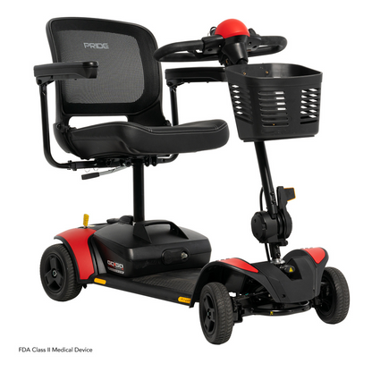 The Pride Mobility Go Go Elite Traveller® 2 Platinum Scooter features a mesh backrest, padded seat, small front basket, and four wheels. Designed for those with mobility challenges. Text: “FDA Class II Medical Device.”.