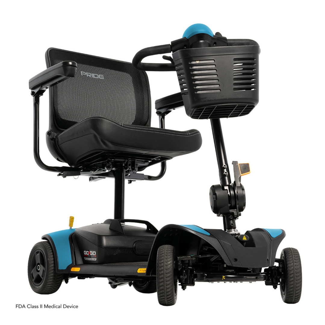 The Pride Mobility Go Go Elite Traveller® 2 Platinum Scooter is a compact black and blue three-wheel scooter featuring a mesh backrest, padded seat, front basket, and is designed for easy transportation and accessibility.