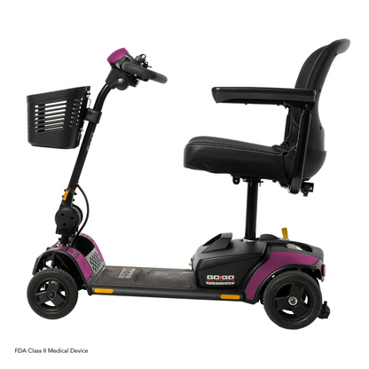 The Pride Mobility Go Go Elite Traveller® 2 Platinum Scooter, shown from the side, features a black and purple frame, three wheels, EZ Turn technology, front basket, adjustable armrests, and a cushioned seat with backrest.