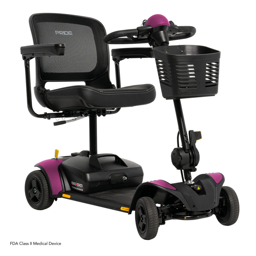 A black and purple Pride Mobility Go Go Elite Traveller® 2 Platinum Scooter with a mesh backrest, padded seat, armrests, front basket, and three wheels; shown on a white background.