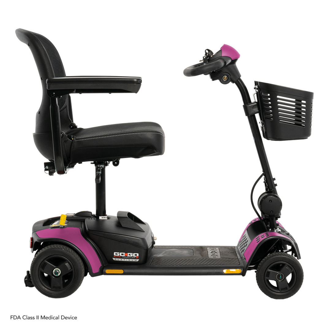 A side view of the Pride Mobility Go Go Elite Traveller® 2 Platinum Scooter, a compact travel scooter with a black seat and armrests, purple base, and black basket on the handlebars—ideal for convenient mobility.