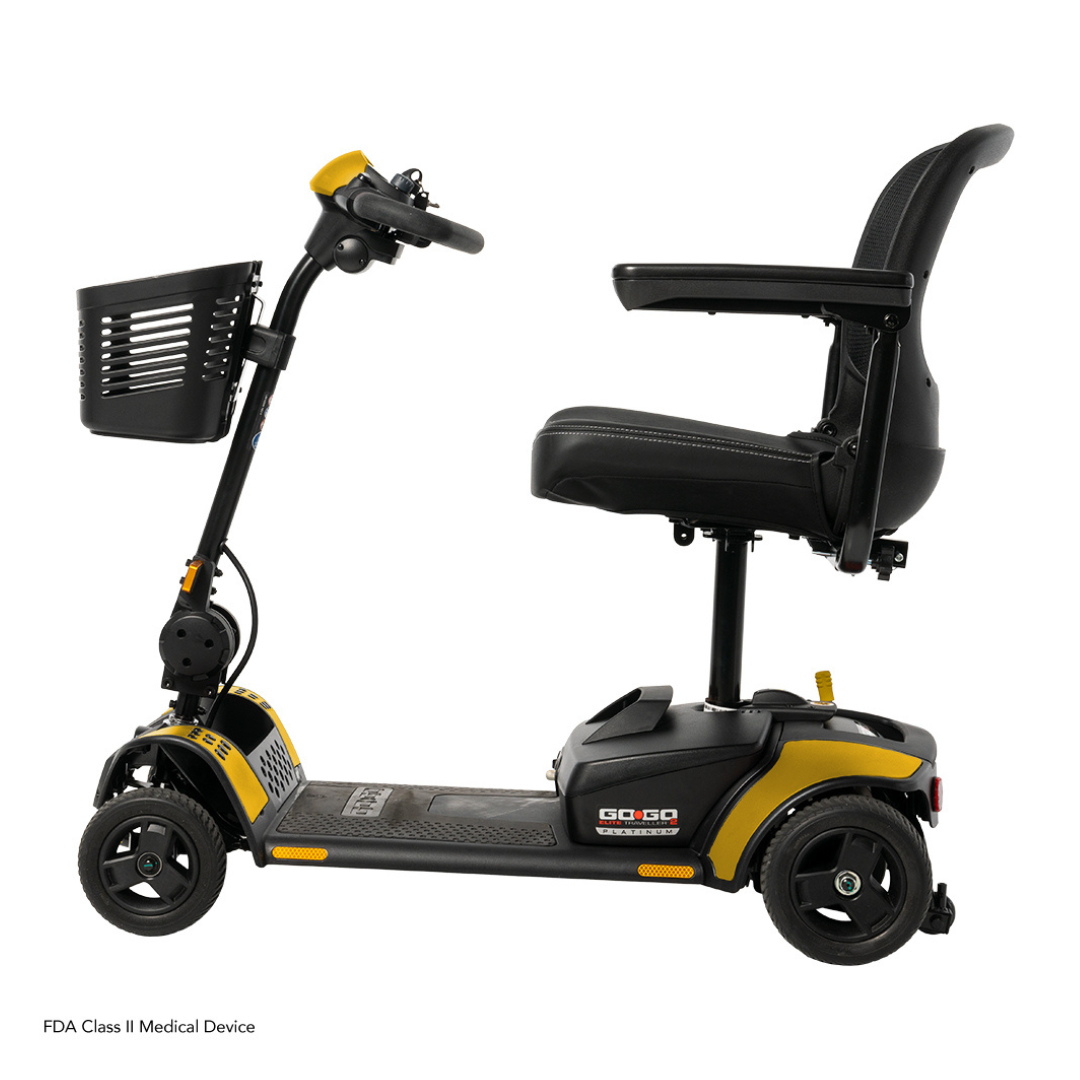A side view of the Pride Mobility Go Go Elite Traveller® 2 Platinum Scooter in black and yellow, featuring a front basket, padded seat with armrests, and EZ Turn technology for easy maneuverability, set against a white background.