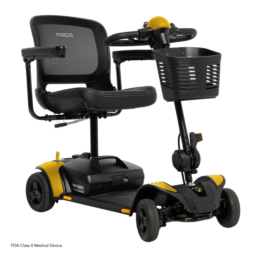 The Pride Mobility Go Go Elite Traveller® 2 Platinum Scooter is a black and yellow travel scooter with EZ Turn technology, mesh backrest, padded seat, armrests, front basket, four wheels, and is designed for personal mobility assistance.