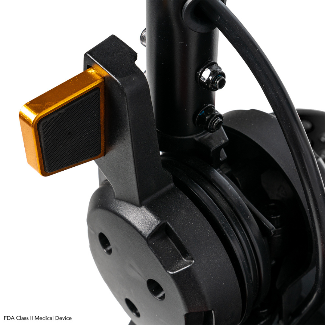 Close-up of a black and gold mechanical part, likely from the Pride Mobility Go Go Elite Traveller® 2 Platinum Scooter, featuring a gold lever with bolts and wires attached to the assembly.