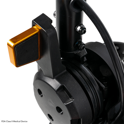Close-up of a black and gold mechanical part, likely from the Pride Mobility Go Go Elite Traveller® 2 Platinum Scooter, featuring a gold lever with bolts and wires attached to the assembly.