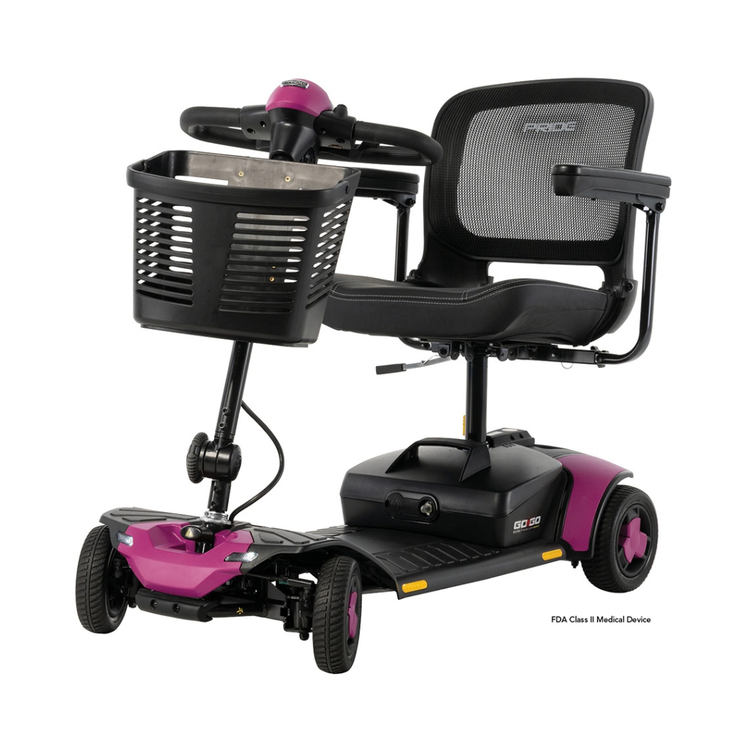 Black and magenta Pride Go Go® Elite Traveller Gen 3 Scooter with four wheels, a front storage basket, and a mesh seat back.