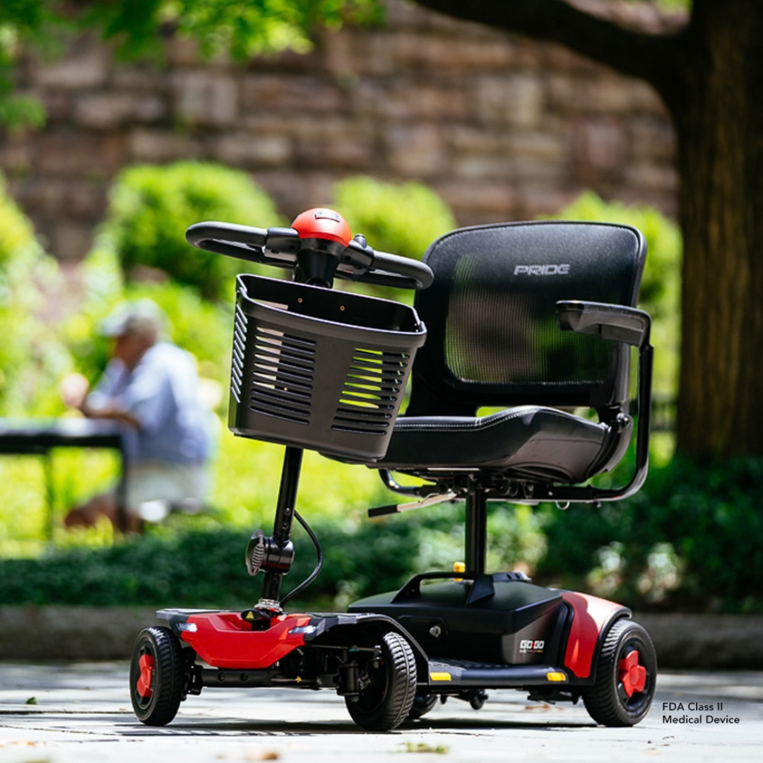 A red and black Pride Go Go® Elite Traveller Gen 3 Scooter featuring a front basket and a mesh seat.