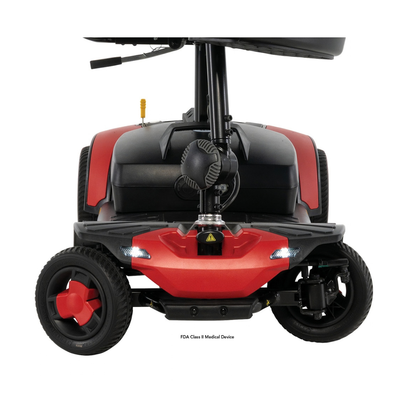Front view of a red and black Pride Go Go® Elite Traveller Gen 3 Scooter, showing the front wheels, LED headlights, and floorboard.