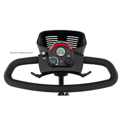 Close-up of a Pride Mobility Go Go® Elite Traveller 3-Wheel Scooters control panel with speed dial, light switch, and battery indicator. Above it is a wire basket. As an FDA Class II Medical Device, its lightweight design offers travel-friendly easy maneuverability for all users.