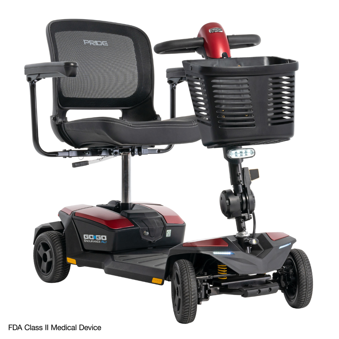 The Pride Mobility Go Go® Endurance AL+ Power Scooter is a four-wheel model with a black mesh seat, armrests, front basket, red accents, grid layout display, and clear Inter font for optimal medical mobility assistance.