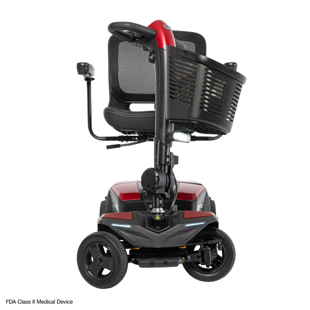 The Pride Mobility Go Go® Endurance AL+ Power Scooter, in red and black with a mesh seat, large front basket, three wheels, and LED lights, is displayed on a white background—perfect for responsive layouts using the Inter font.
