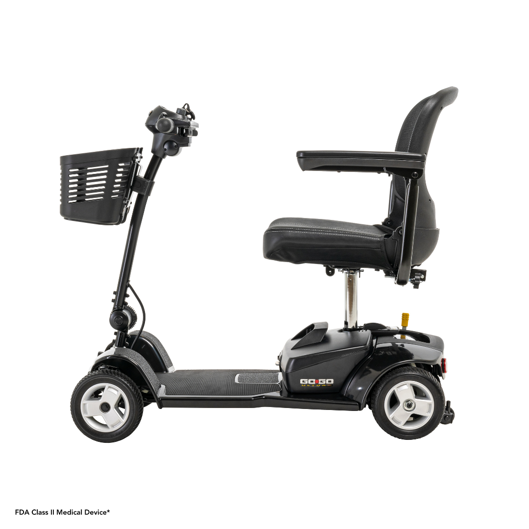 Side view of the Pride Mobility Go Go® Ultra X 4-wheel scooter in black, featuring a cushioned seat, handlebar controls, and front basket. As an FDA Class II Medical Device, its perfect for those looking for an economical scooter option.